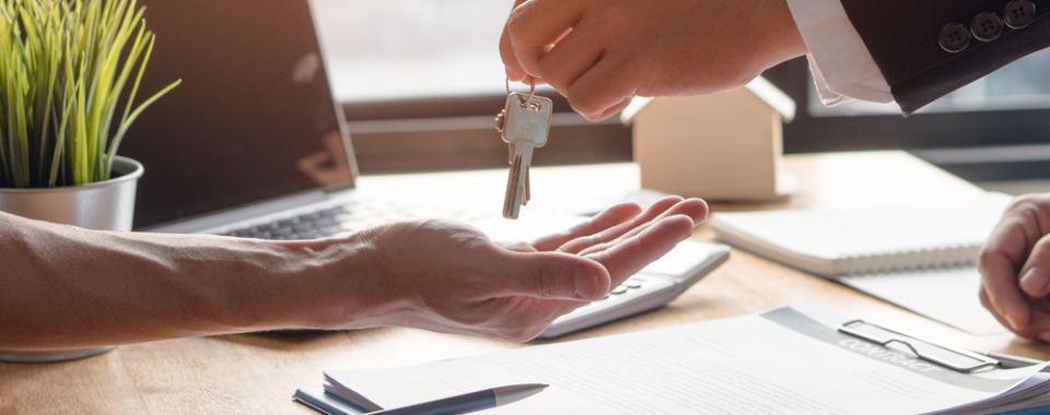 Realtor and Mortgage lender handing the keys to the buyer