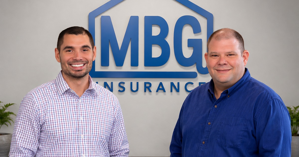 Kirk Reisner and Brandon Thompson in front of a MBG logo